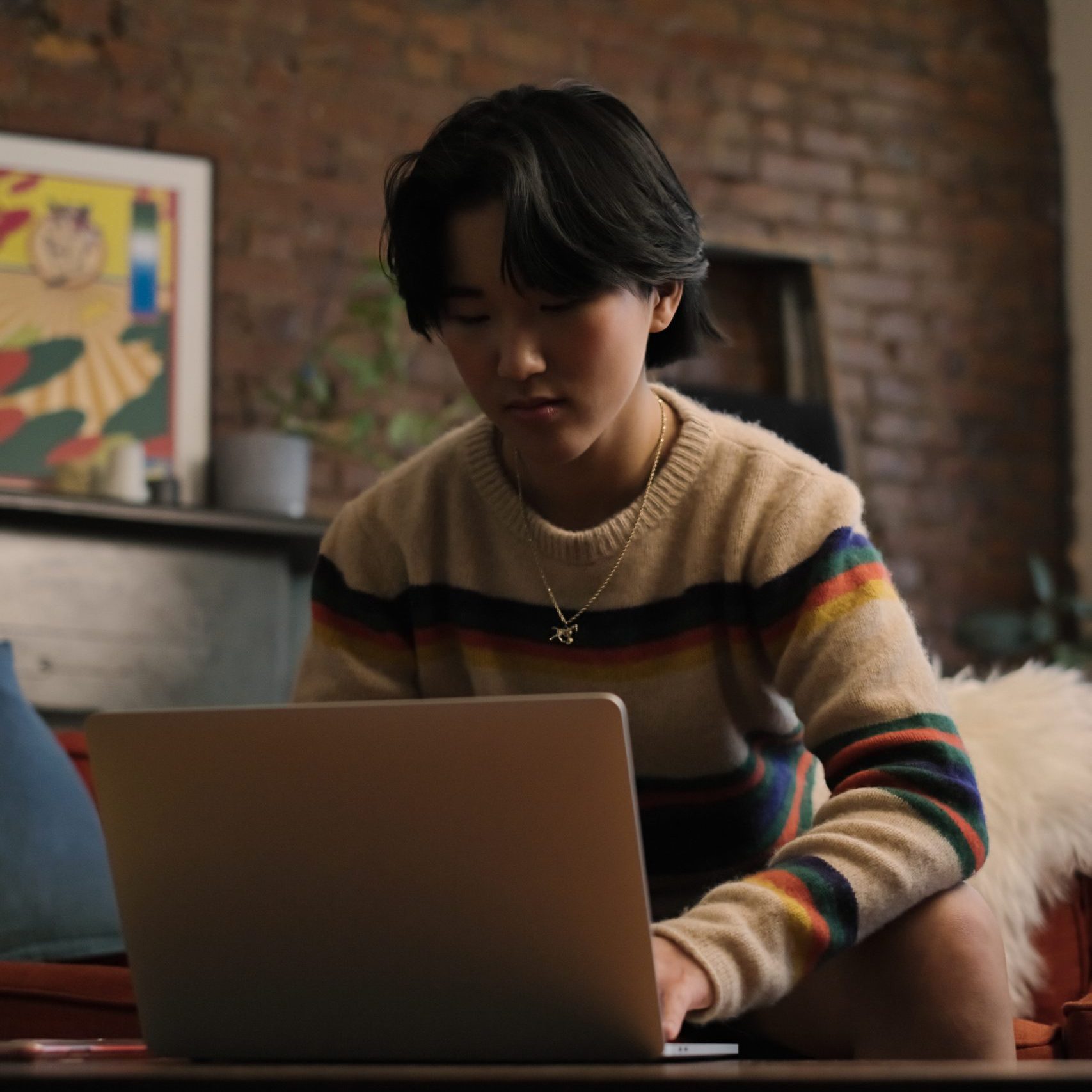 A non-binary person looking at a cellphone (1)