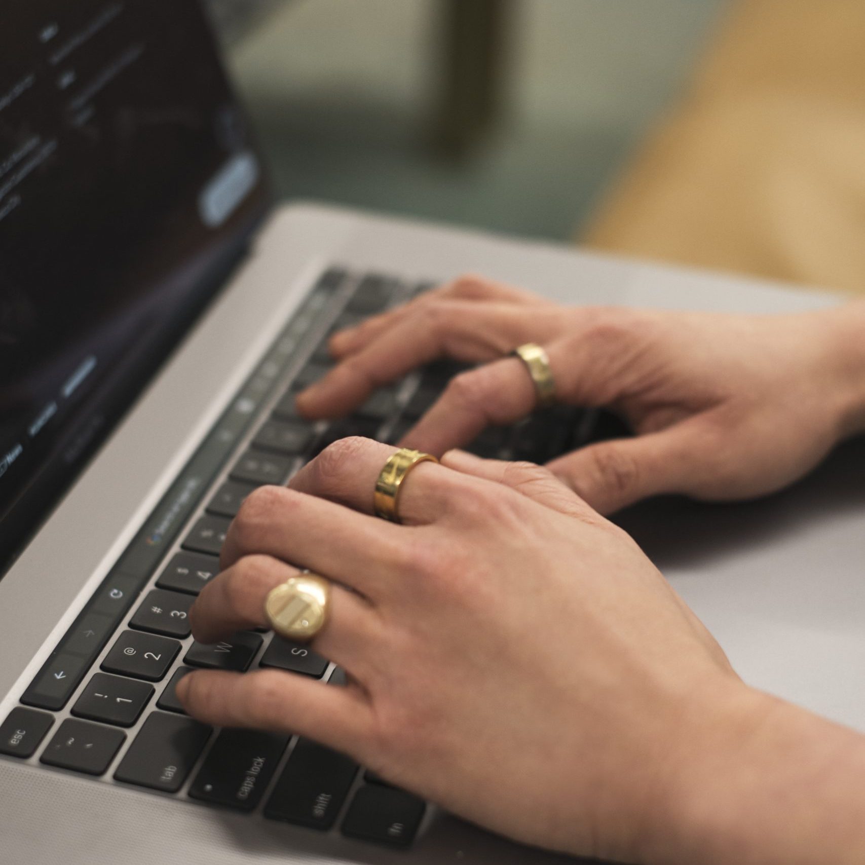 Close-up of a non-binary person using a laptop